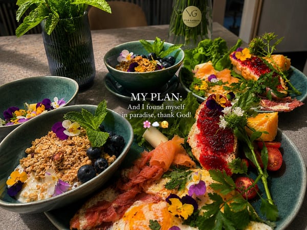 Breakfast table at Vila Garufa with homemade granola, salmon and edible flowers
